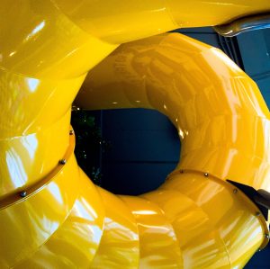 Yellow tube slide seen from above as the slide curves into a loop. This is the kind of slide that my daughter used in the story I told in my post.